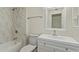 Bright bathroom featuring a shower-tub combo, marble tile surround, and white vanity with a square sink at 14024 N Palm Ridge Dr, Sun City, AZ 85351