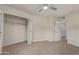 Carpeted bedroom featuring access to the closet and bathroom at 14024 N Palm Ridge Dr, Sun City, AZ 85351