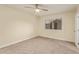 A carpeted bedroom featuring a window, ceiling fan and closet for optimal comfort and storage at 14024 N Palm Ridge Dr, Sun City, AZ 85351