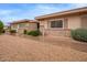 Low maintenance landscaped front exterior with mature shrubbery and brick accents at 14024 N Palm Ridge Dr, Sun City, AZ 85351