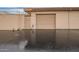 Exterior view of a garage with an automatic door, complemented by matching siding and a paved driveway at 14024 N Palm Ridge Dr, Sun City, AZ 85351