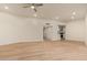 Living room with wood-look floors, ceiling fan and open floor plan at 14024 N Palm Ridge Dr, Sun City, AZ 85351