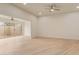 Bright living room with wood-look floors, ceiling fan, and sliding glass doors to back patio at 14024 N Palm Ridge Dr, Sun City, AZ 85351