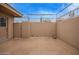 Enclosed patio with concrete flooring, brick walls, and a secured gate, offering privacy and security at 14024 N Palm Ridge Dr, Sun City, AZ 85351