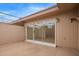 Private patio area featuring neutral concrete, sliding glass doors, and a fenced-in outdoor space at 14024 N Palm Ridge Dr, Sun City, AZ 85351