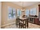 Charming dining area features ample natural light, a table with seating, and a beverage cooler at 14870 W Aldea Cir, Litchfield Park, AZ 85340