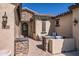 Inviting front porch adorned with stone accents, a wrought iron door, and comfortable seating at 14870 W Aldea Cir, Litchfield Park, AZ 85340