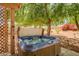 Backyard featuring an in-ground hot tub covered by a lattice-covered pergola at 14932 W Lamoille Dr, Surprise, AZ 85374