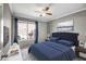 Bedroom featuring an upholstered headboard, grey walls, and a view of the back yard at 14932 W Lamoille Dr, Surprise, AZ 85374