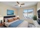 Cozy bedroom featuring a ceiling fan and window view, alongside tasteful decor at 14932 W Lamoille Dr, Surprise, AZ 85374