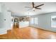 This wide-angle shows a living room open to the kitchen, with hardwood floors and neutral paint at 14932 W Lamoille Dr, Surprise, AZ 85374