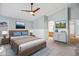 Cozy main bedroom with neutral walls, a ceiling fan, and en-suite bathroom access at 14932 W Lamoille Dr, Surprise, AZ 85374