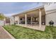 Outdoor entertaining area with covered patio, barbecue, ping pong table, and lush artificial lawn at 15327 E Thistle Dr, Fountain Hills, AZ 85268