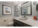 Powder room with textured walls, decorative mirror, and framed artwork at 15327 E Thistle Dr, Fountain Hills, AZ 85268