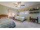 Bright bedroom featuring twin beds, vintage desk, and decorative shelving at 15327 E Thistle Dr, Fountain Hills, AZ 85268