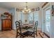 Cozy breakfast nook with a round table, chandelier lighting, and natural light from windows with plantation shutters at 15327 E Thistle Dr, Fountain Hills, AZ 85268