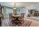 Formal dining room with a large wooden table, antique furniture, chandelier lighting, and an open floor plan at 15327 E Thistle Dr, Fountain Hills, AZ 85268