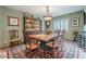 Formal dining room with a large wooden table, antique furniture, chandelier lighting, and an elegant area rug at 15327 E Thistle Dr, Fountain Hills, AZ 85268