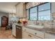 Kitchen sink with granite countertops and a window that overlooks an outdoor garden, stainless steel appliances at 15327 E Thistle Dr, Fountain Hills, AZ 85268