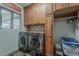 Updated laundry room equipped with new washer and dryer and wooden cabinets at 15327 E Thistle Dr, Fountain Hills, AZ 85268