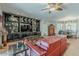 Cozy living room with built-in shelving, comfortable seating, and a view into the dining area at 15327 E Thistle Dr, Fountain Hills, AZ 85268