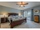 Spacious main bedroom with a king-size bed, ceiling fan, and sliding glass doors that lead to a patio at 15327 E Thistle Dr, Fountain Hills, AZ 85268