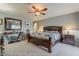 Comfortable main bedroom with a king-size bed, ceiling fan, side tables with lamps and neutral walls at 15327 E Thistle Dr, Fountain Hills, AZ 85268