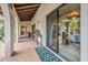 Covered patio featuring terracotta tile, decorative rugs, and views of the interior at 15327 E Thistle Dr, Fountain Hills, AZ 85268