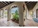 Inviting covered patio with terracotta tile, arched openings, and views of the pool at 15327 E Thistle Dr, Fountain Hills, AZ 85268