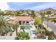 Aerial view of a private pool and patio surrounded by lush landscaping and palm trees at 15327 E Thistle Dr, Fountain Hills, AZ 85268