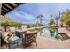 Sparkling pool with lounge area, lush landscaping, and a picturesque desert backdrop at 15327 E Thistle Dr, Fountain Hills, AZ 85268