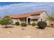 Charming single-story home with desert landscaping including mature trees and gravel ground cover at 15334 W Via Montoya --, Sun City West, AZ 85375