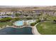 Aerial view showcasing the community's pool, lake, clubhouse, and green spaces at 15577 S 181St Ln, Goodyear, AZ 85338