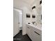 Modern bathroom featuring double sinks, black hardware, and an open door view to a tub/shower combination at 15577 S 181St Ln, Goodyear, AZ 85338