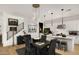 Dining area with stylish light fixture, wood floors, and open layout to the kitchen at 15577 S 181St Ln, Goodyear, AZ 85338