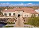 Exterior shot showcasing the building's entrance and tile roof in a beautifully landscaped setting at 15577 S 181St Ln, Goodyear, AZ 85338