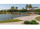 Beautiful lakefront area featuring a walking path, mature trees and clubhouse at 15577 S 181St Ln, Goodyear, AZ 85338