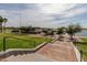 Scenic lakeside view with picnic areas, gazebos, and paved walkways overlooking the water at 15577 S 181St Ln, Goodyear, AZ 85338