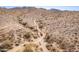 Desert landscape aerial shot showing a dirt trail winding through the rugged terrain at 15577 S 181St Ln, Goodyear, AZ 85338