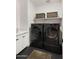 Efficient laundry room featuring side-by-side front load washer and dryer, with clean white counters at 15577 S 181St Ln, Goodyear, AZ 85338