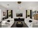 Bright living room with modern light fixture, neutral paint, and coordinated decor at 15577 S 181St Ln, Goodyear, AZ 85338