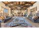 Expansive lobby featuring elegant seating areas, high ceilings with wood beams, and a stylish fireplace at 15577 S 181St Ln, Goodyear, AZ 85338