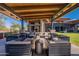 Outdoor lounge area with comfortable seating, stone pillars, and a view of the Welcome Center at 15577 S 181St Ln, Goodyear, AZ 85338