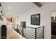 Upstairs hallway featuring wood floors, modern art, and contemporary railing at 15577 S 181St Ln, Goodyear, AZ 85338