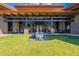 Exterior view of the Welcome Center with a stone facade, wooden beams, and manicured lawn at 15577 S 181St Ln, Goodyear, AZ 85338