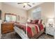 Comfortable bedroom featuring light color walls, bright natural light, and a ceiling fan at 1562 W Lacewood Pl, Phoenix, AZ 85045