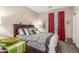 Comfortable bedroom featuring a decorative bedspread, window with red curtains, and neutral paint color at 1562 W Lacewood Pl, Phoenix, AZ 85045