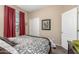 Cozy bedroom featuring a decorated bedspread, bright natural light, and neutral walls at 1562 W Lacewood Pl, Phoenix, AZ 85045