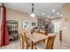 Charming dining area with a wooden table, chandelier, and convenient access to the kitchen at 1562 W Lacewood Pl, Phoenix, AZ 85045