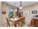 Bright dining area with tile flooring, sliding glass doors and seating for six people at 1562 W Lacewood Pl, Phoenix, AZ 85045